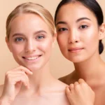 Two smiling women with radiant healthy skin illustrating aesthetic wellness
