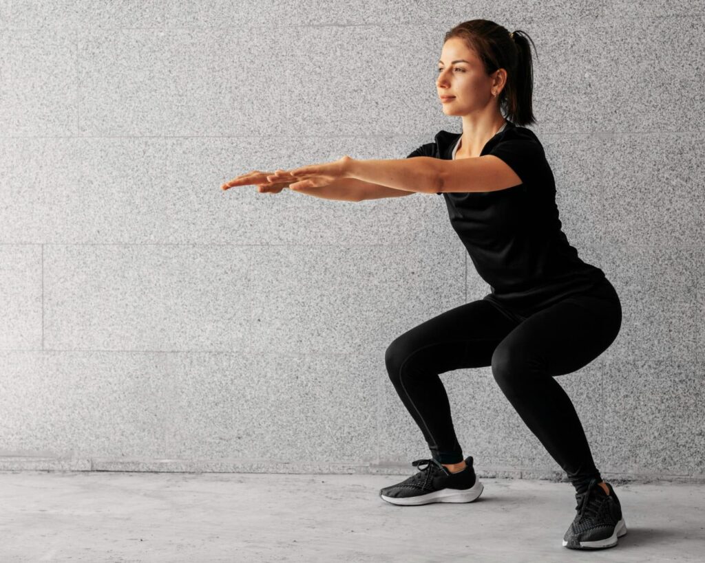 Woman in activewear performing a squat, representing staying active and keeping a stable weight after a skinny BBL